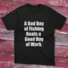 Black T-shirt with bold white text saying "A bad day of fishing beats a good day of work," shown on a light blue background.