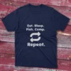 T-shirt in navy blue featuring "Eat, Sleep, Fish, Camp" and the word "Repeat" with circular arrows on a light blue background.