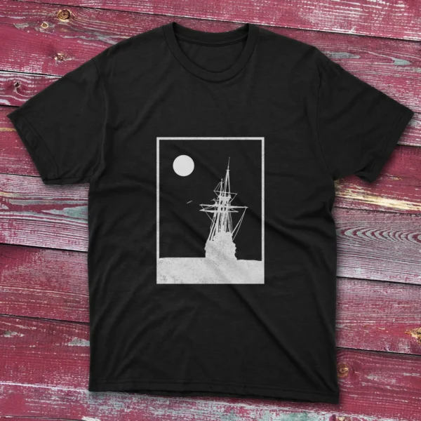 Black T-shirt with a white square stroke design of an old ship landing on the ocean, shown on a light blue background.