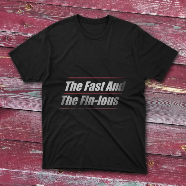 Black T-shirt on a ligh blue background containing the words "The Fast And The Fin-ious" in bold white text with horizontal red lines.