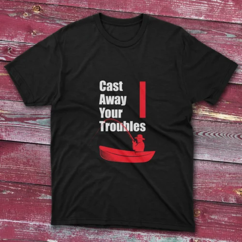 A fishing t-shirt image on a lite blue square contain a design of someone fishing on a boat with the phrase "Cast Away Your Troubles"