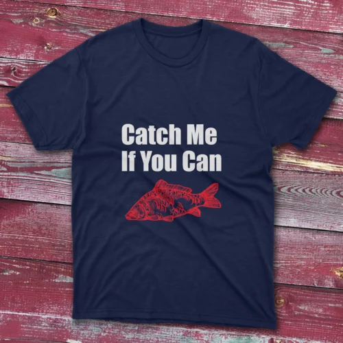 Navy fishing T-shirt featuring the phrase "Catch me if you can" in bold white text with a red fish illustration, set against a light blue background.