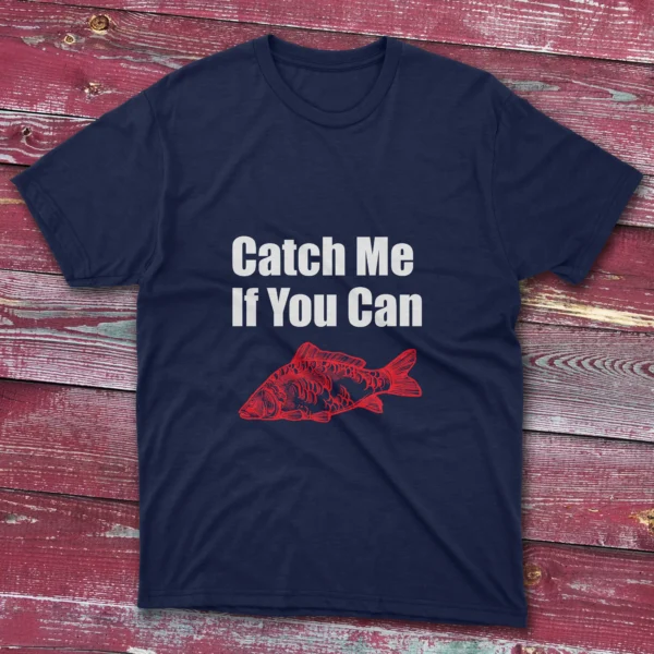 Navy fishing T-shirt featuring the phrase "Catch me if you can" in bold white text with a red fish illustration, set against a light blue background.