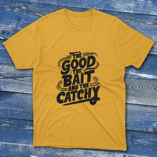 yellow T-shirt featuring the phrase "The Good, The Bait, And The Catchy" with bold fishing elements, displayed on a light blue background.