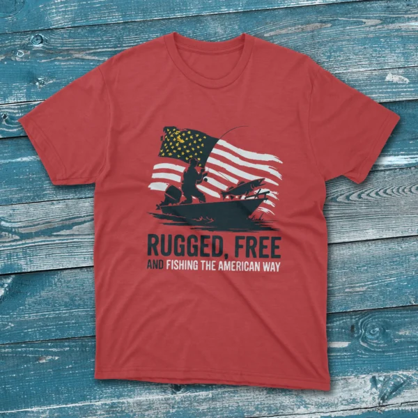 A red T-shirt featuring the bold phrase "Rugged, Free And Fishing The American Way" in blue & white text. with a silhouette of man fishing on a boat