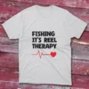 White T-shirt showcasing Fishing it's the reel therapy - 2025 text